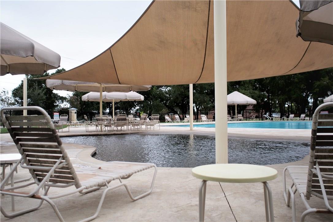 2204 Old Sterling Road Cedar Park, TX 78613 - Photo 20 of 22 a view of a swimming pool with a table and chairs under an umbrella