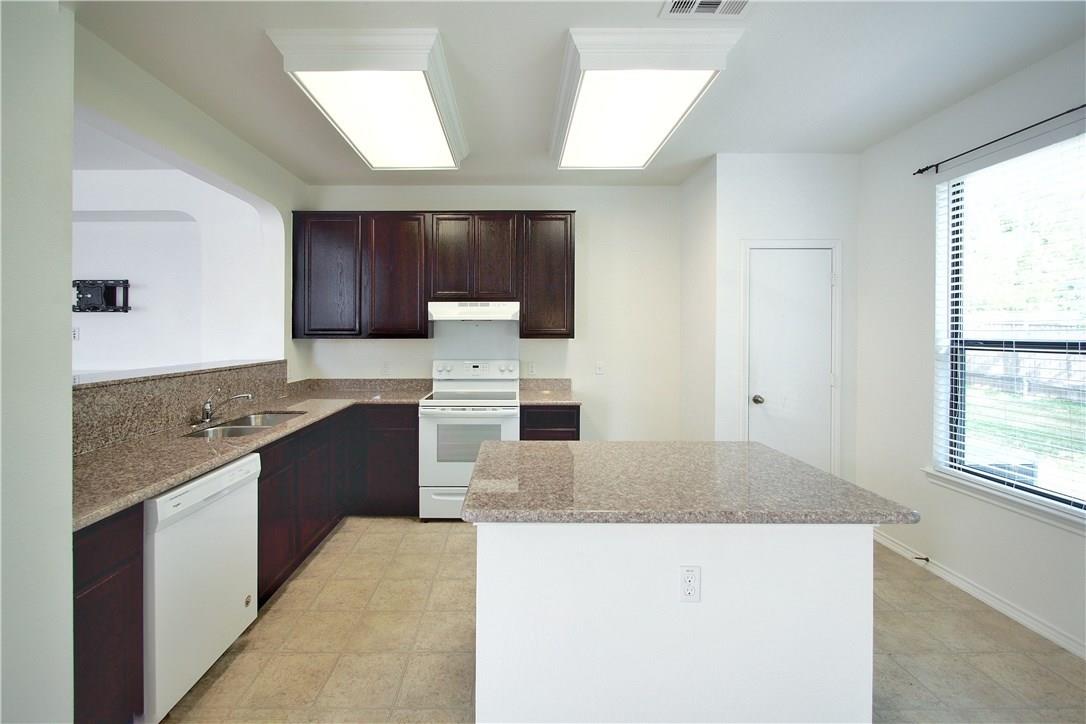 2204 Old Sterling Road Cedar Park, TX 78613 - Photo 7 of 22 a large kitchen with granite countertop a sink and a stove