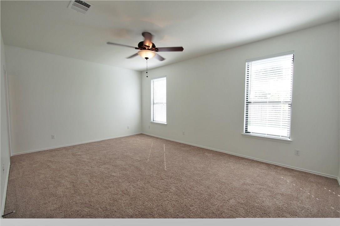 2204 Old Sterling Road Cedar Park, TX 78613 - Photo 8 of 22 an empty room with windows and ceiling fan
