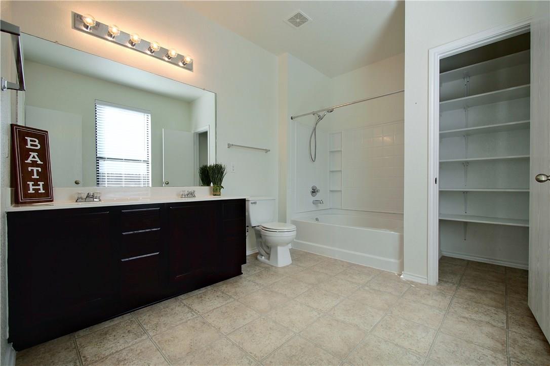 2204 Old Sterling Road Cedar Park, TX 78613 - Photo 9 of 22 a bathroom with a double vanity sink toilet and shower