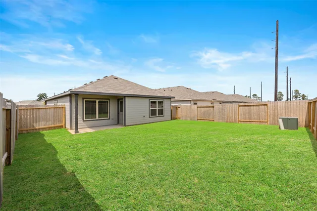 a view of a yard with a house in the background