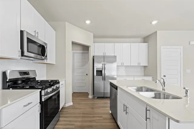 a kitchen with a sink cabinets and stainless steel appliances