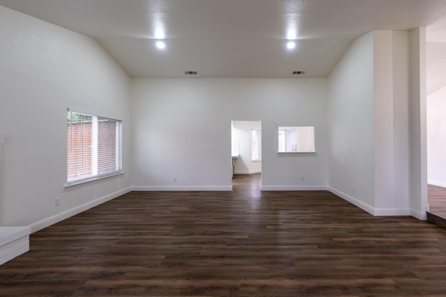 899 La Jolla Way Merced, CA 95348 - Photo 15 of 51 an empty room with wooden floor and windows