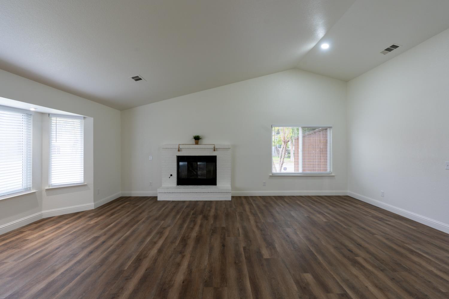 899 La Jolla Way Merced, CA 95348 - Photo 16 of 51 wooden floor in an empty room with a window