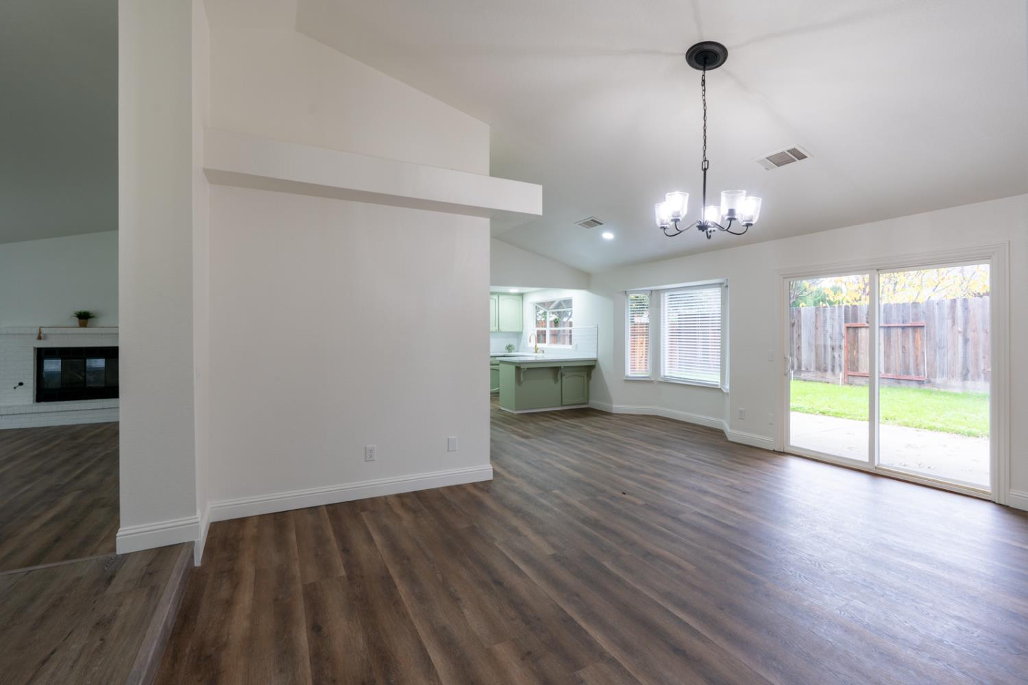 899 La Jolla Way Merced, CA 95348 - Photo 18 of 51 a view of an empty room with wooden floor and a window