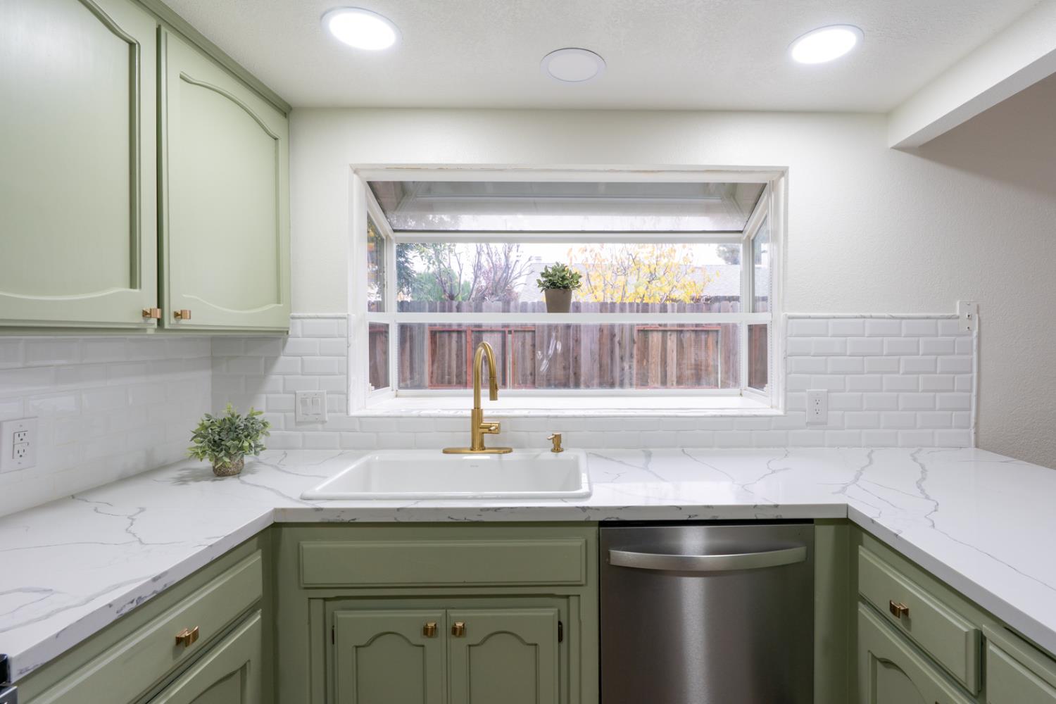 899 La Jolla Way Merced, CA 95348 - Photo 27 of 51 a kitchen with a sink and cabinets
