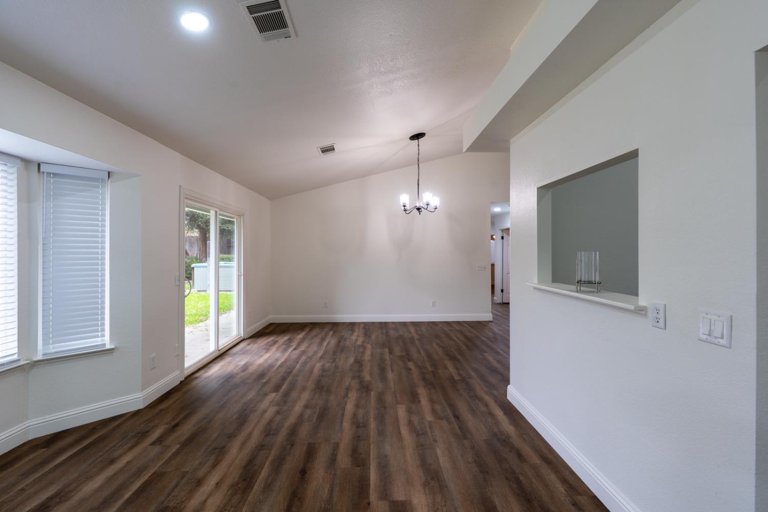 899 La Jolla Way Merced, CA 95348 - Photo 29 of 51 an empty room with wooden floor and windows