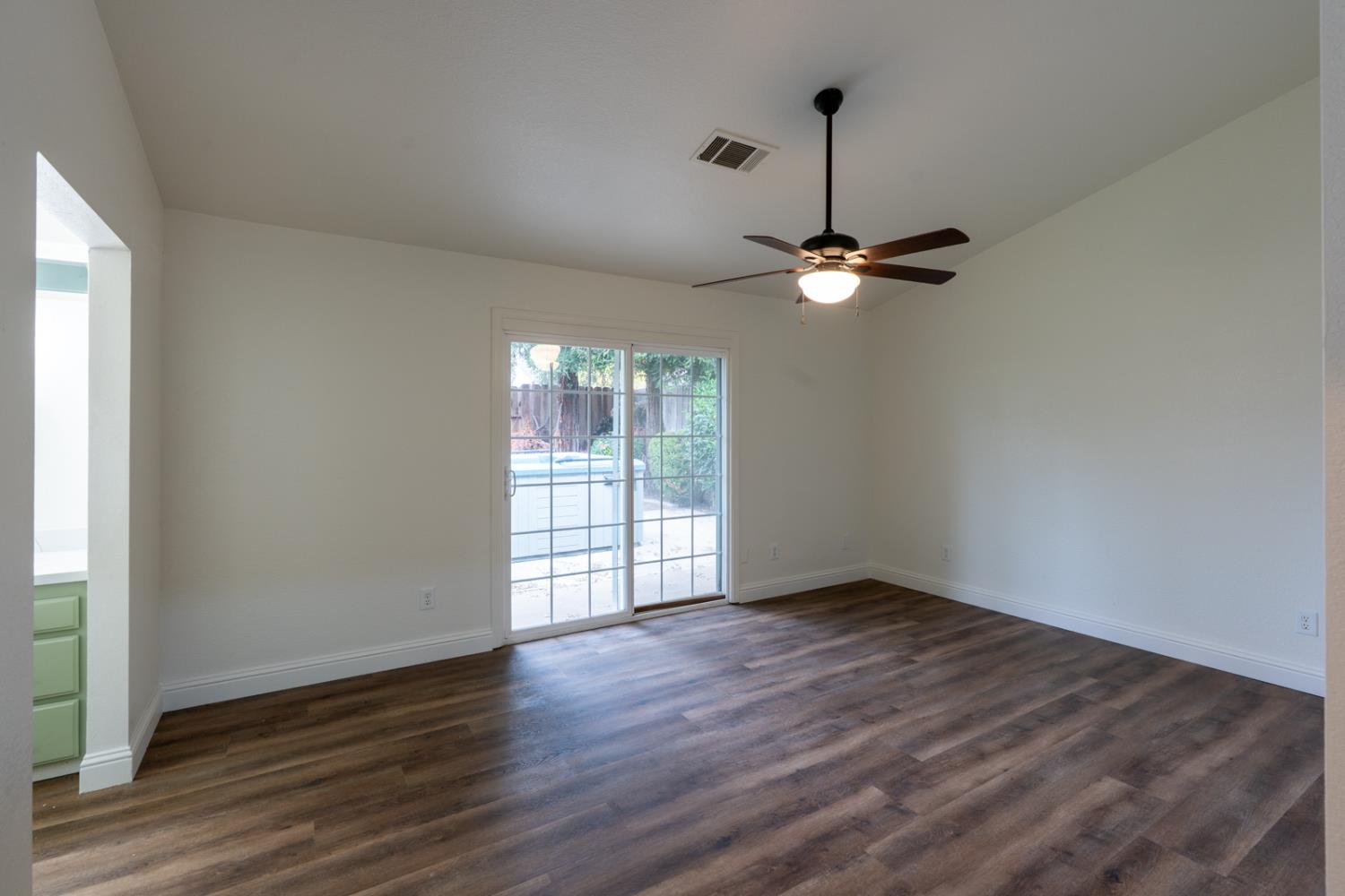 899 La Jolla Way Merced, CA 95348 - Photo 33 of 51 a view of an empty room with wooden floor and a window