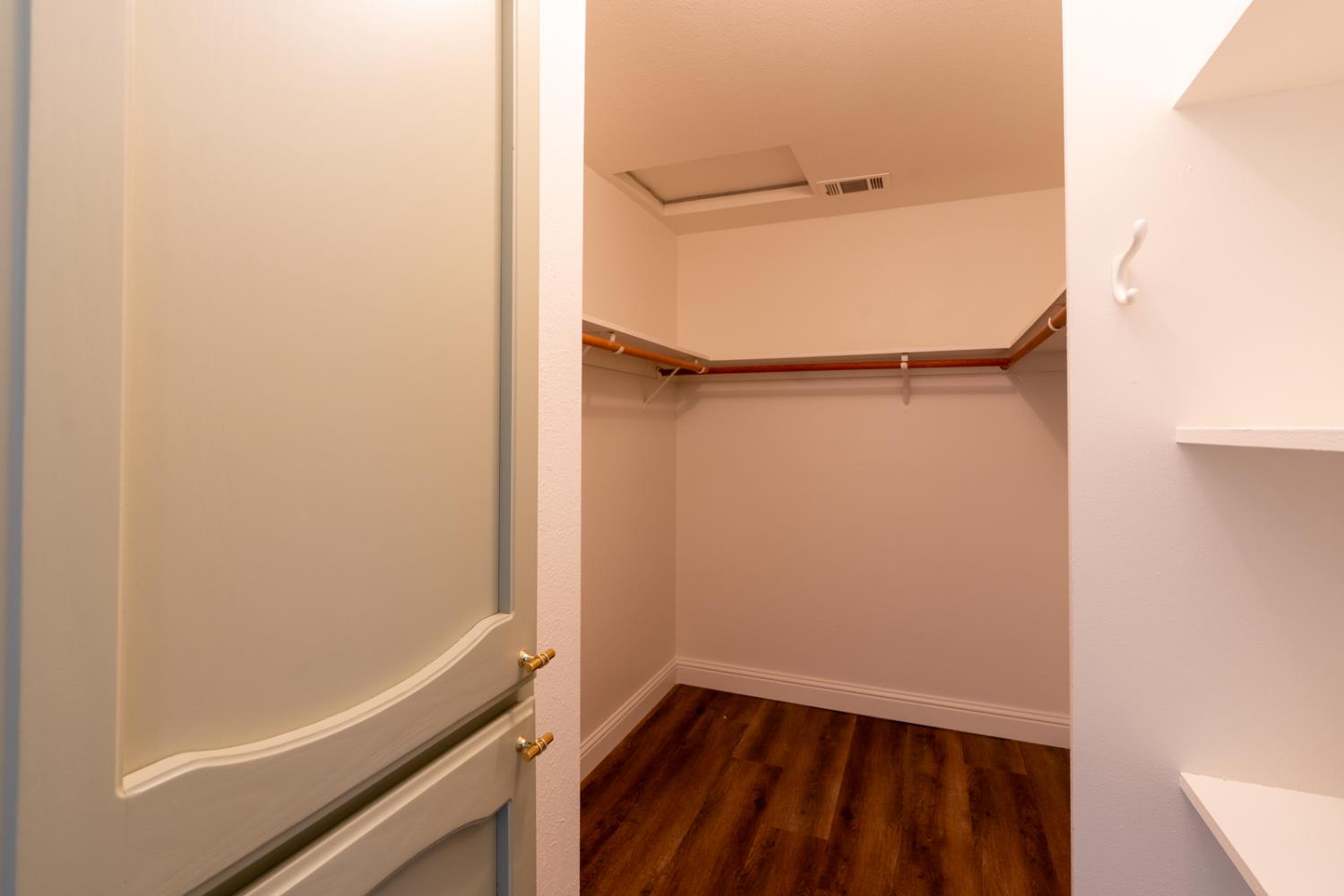 899 La Jolla Way Merced, CA 95348 - Photo 35 of 51 a view of walk in closet with empty racks