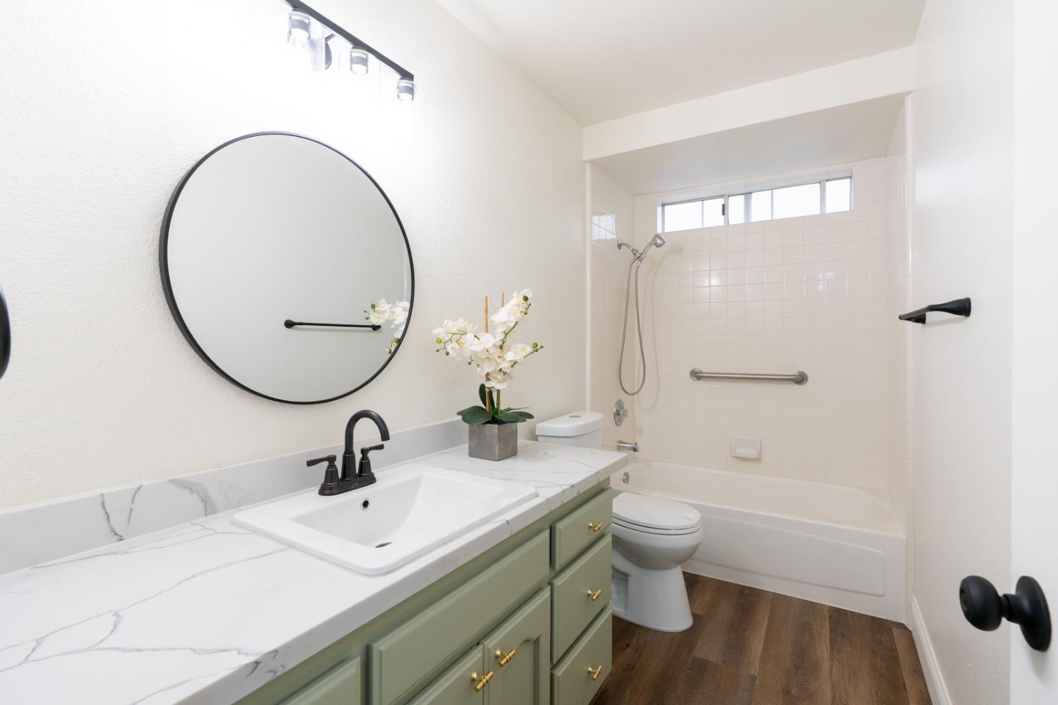 899 La Jolla Way Merced, CA 95348 - Photo 43 of 51 a bathroom with a sink a toilet and a mirror