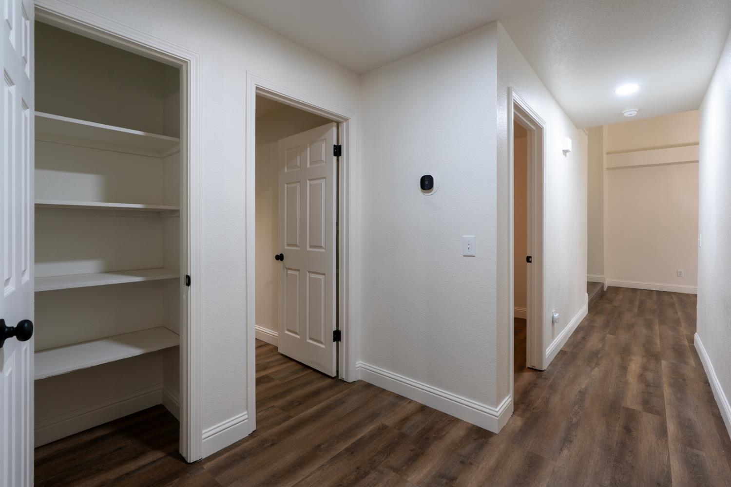 899 La Jolla Way Merced, CA 95348 - Photo 46 of 51 a view of a hallway with wooden floor and closet