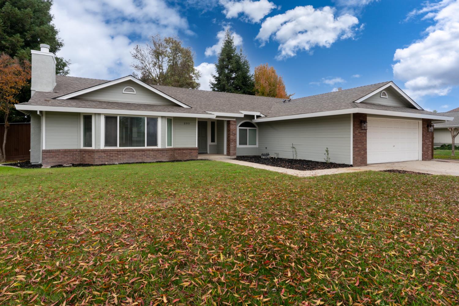 899 La Jolla Way Merced, CA 95348 - Photo 5 of 51 a front view of a house with a garden