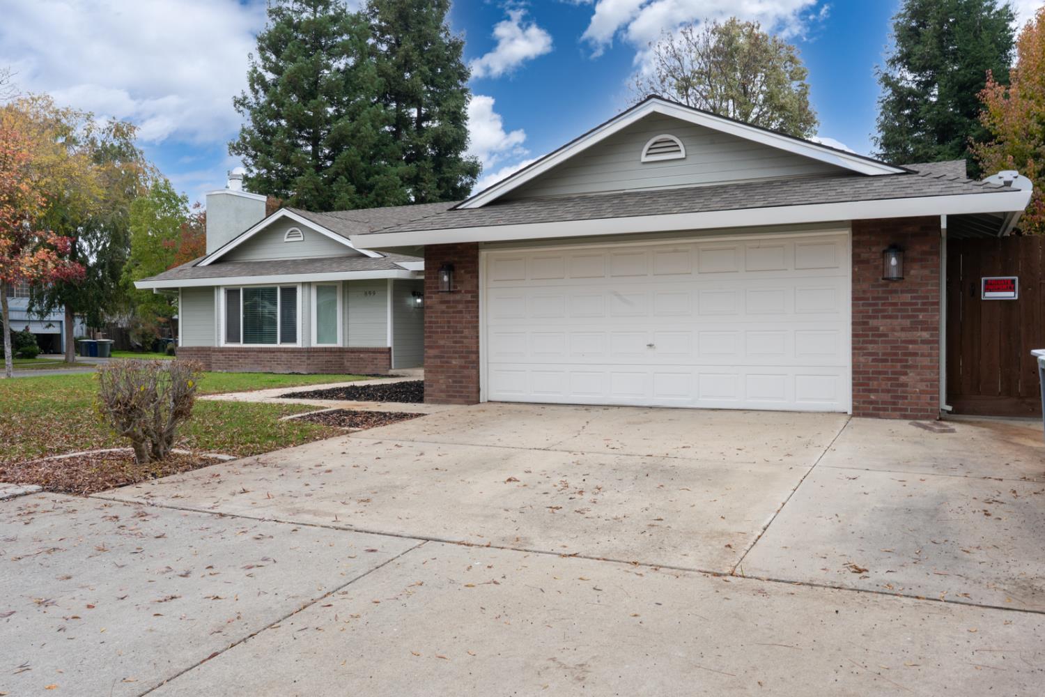 899 La Jolla Way Merced, CA 95348 - Photo 7 of 51 a front view of a house with a yard and garage