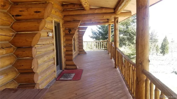 a view of a balcony with wooden floor and fence