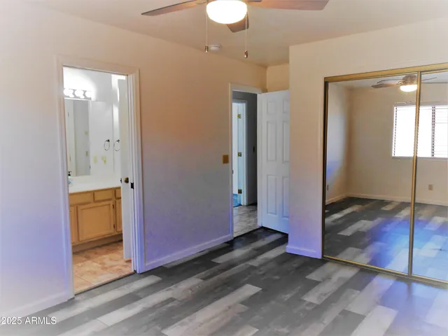 a view of a room with wooden floor and cabinet