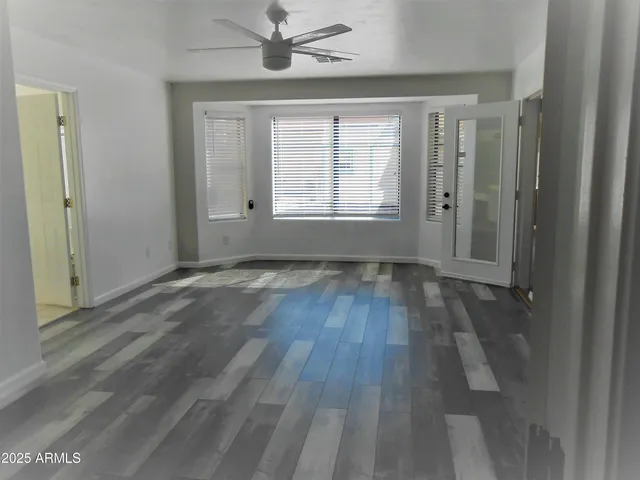 wooden floor in an empty room with a window