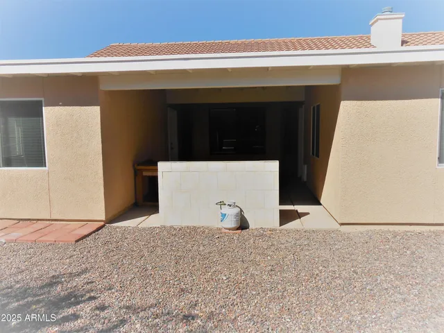 a view of a house with a backyard