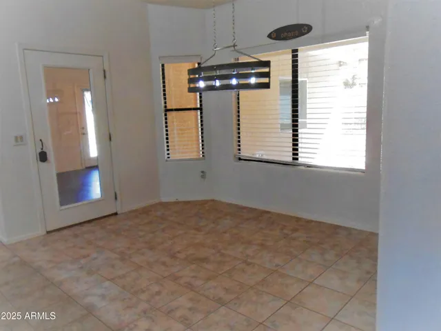 an empty room with windows and entrance