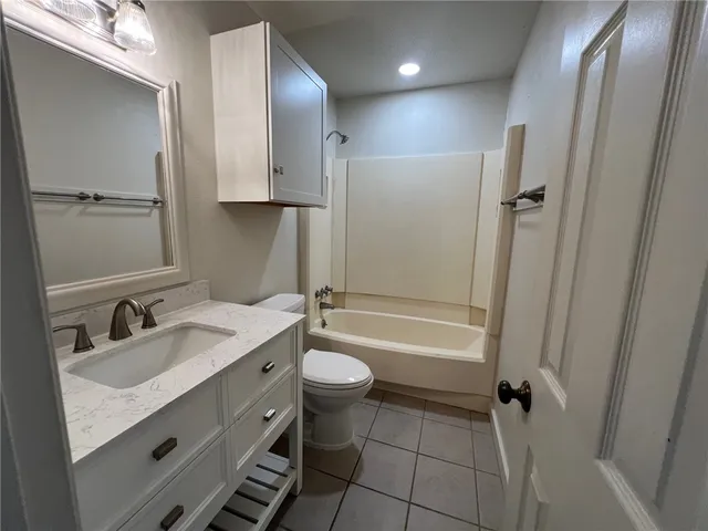 a bathroom with a double vanity sink toilet mirror and bathtub