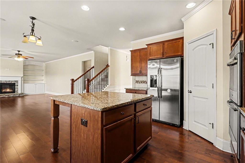 4208 Amberleaf Walk Lilburn, GA 30047 - Photo 15 of 33 a kitchen with stainless steel appliances granite countertop a refrigerator a sink dishwasher a stove and a wooden floors