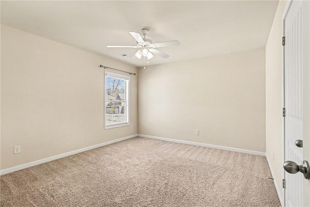 4208 Amberleaf Walk Lilburn, GA 30047 - Photo 23 of 33 an empty room with windows and fan