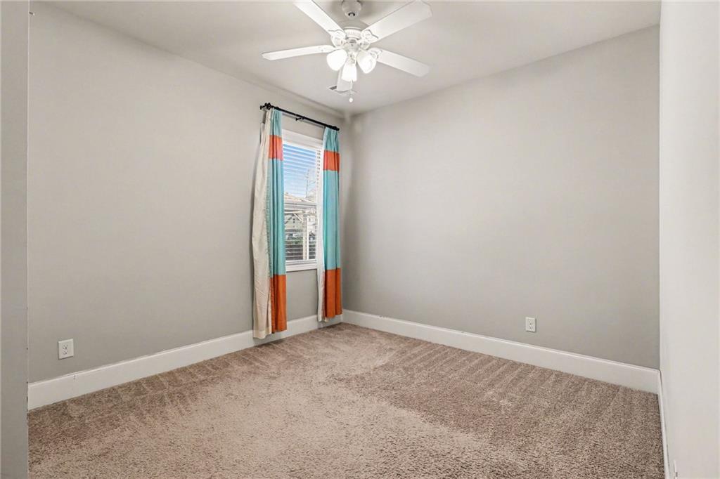 4208 Amberleaf Walk Lilburn, GA 30047 - Photo 25 of 33 an empty room with closet and a chandelier fan