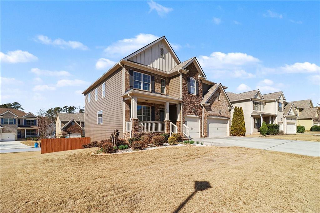 4208 Amberleaf Walk Lilburn, GA 30047 - Photo 4 of 33 a front view of a house with a yard