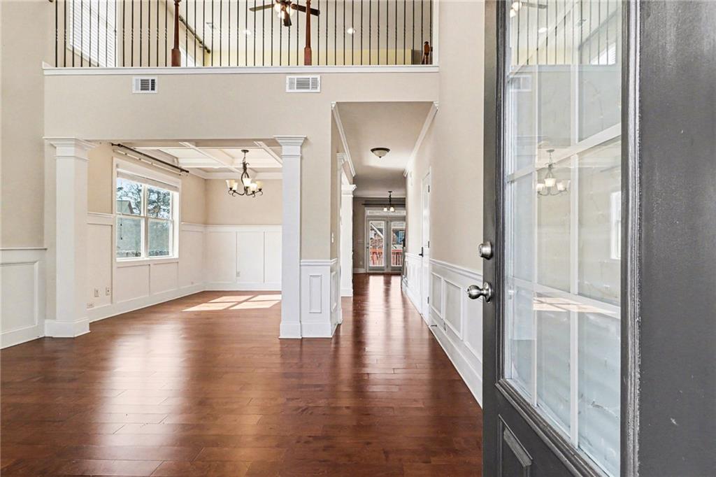 4208 Amberleaf Walk Lilburn, GA 30047 - Photo 5 of 33 a view of a hallway with wooden floor and stairs