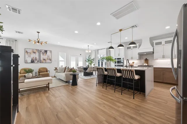 a living room with lots of furniture and kitchen view