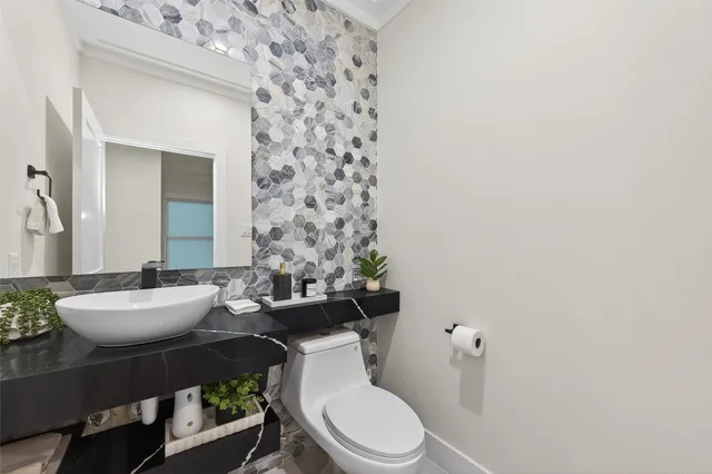 a white toilet sitting next to a bathroom sink