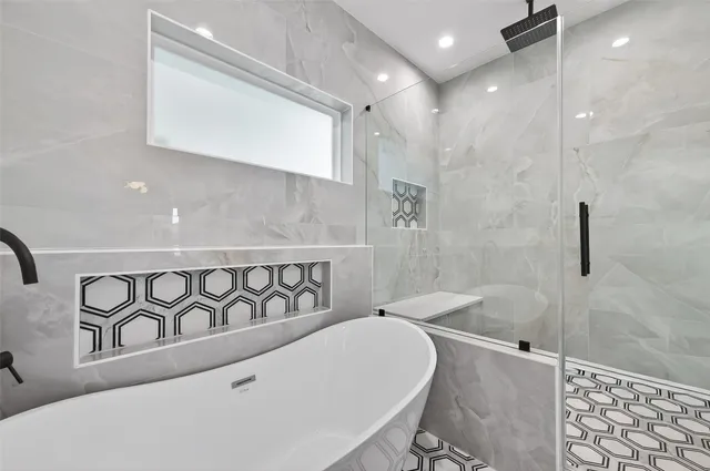 a bathroom with a bathtub and shower