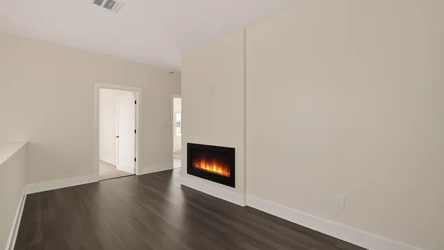 a room with wooden floor and fireplace