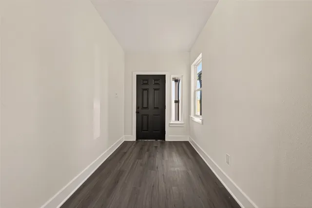 a view of hallway with wooden floor