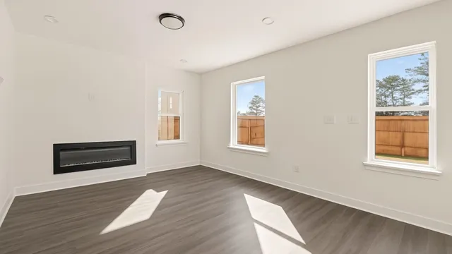 a view of a livingroom with wooden floor and window