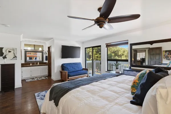 a spacious bedroom with a large bed and a large window