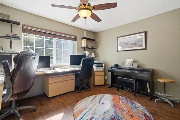 a view of a workspace with furniture and a window