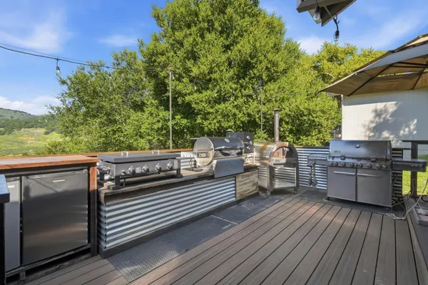 a view of a balcony with wooden floor and outdoor seating