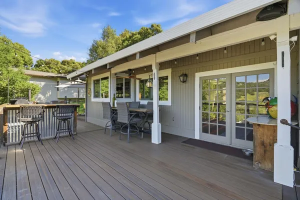 a view of a patio with table and chairs and wooden floor