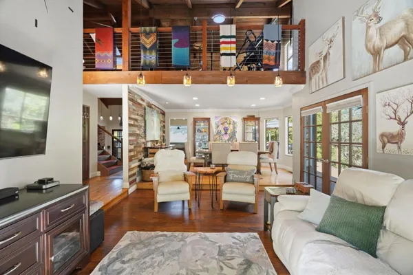 a living room with fireplace furniture and a flat screen tv