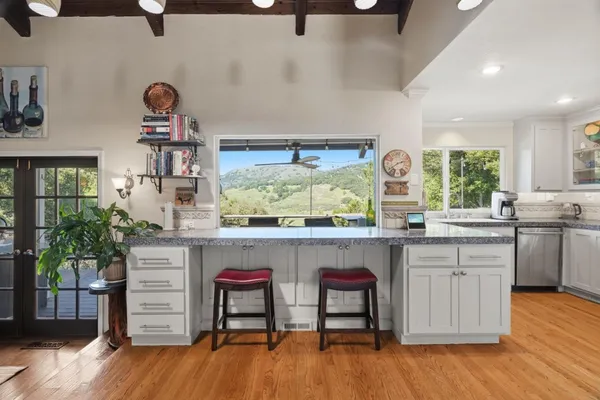 a kitchen with a wooden floor and window
