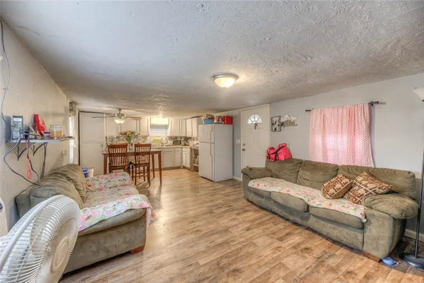 a living room with furniture and kitchen view