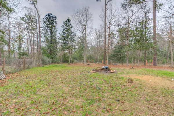 a view of a backyard with large trees