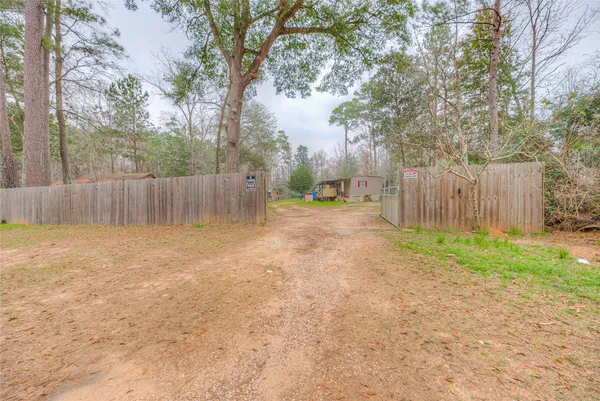 a backyard of a house with a swing and tree