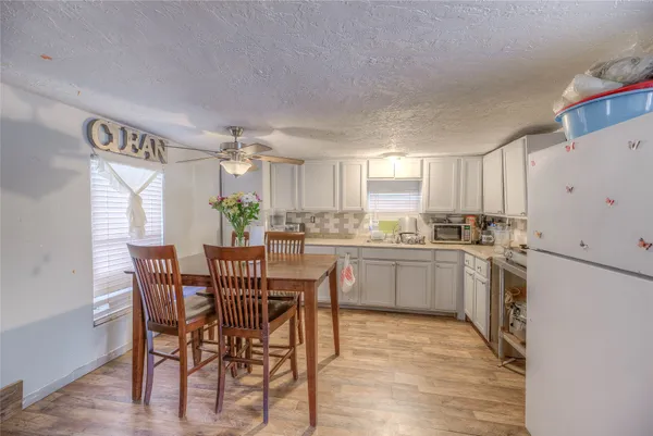 a kitchen with a table and chairs in it