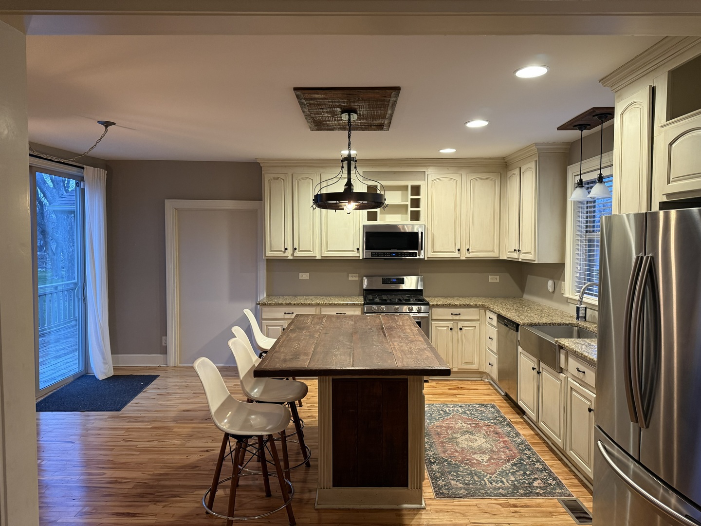 42W546 Highway 64 St. Charles, IL 60175 - Photo 7 of 18 a kitchen with stainless steel appliances a dining table chairs stove refrigerator and cabinets