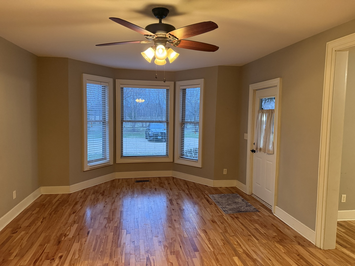 42W546 Highway 64 St. Charles, IL 60175 - Photo 10 of 18 a view of an empty room with wooden floor and fan