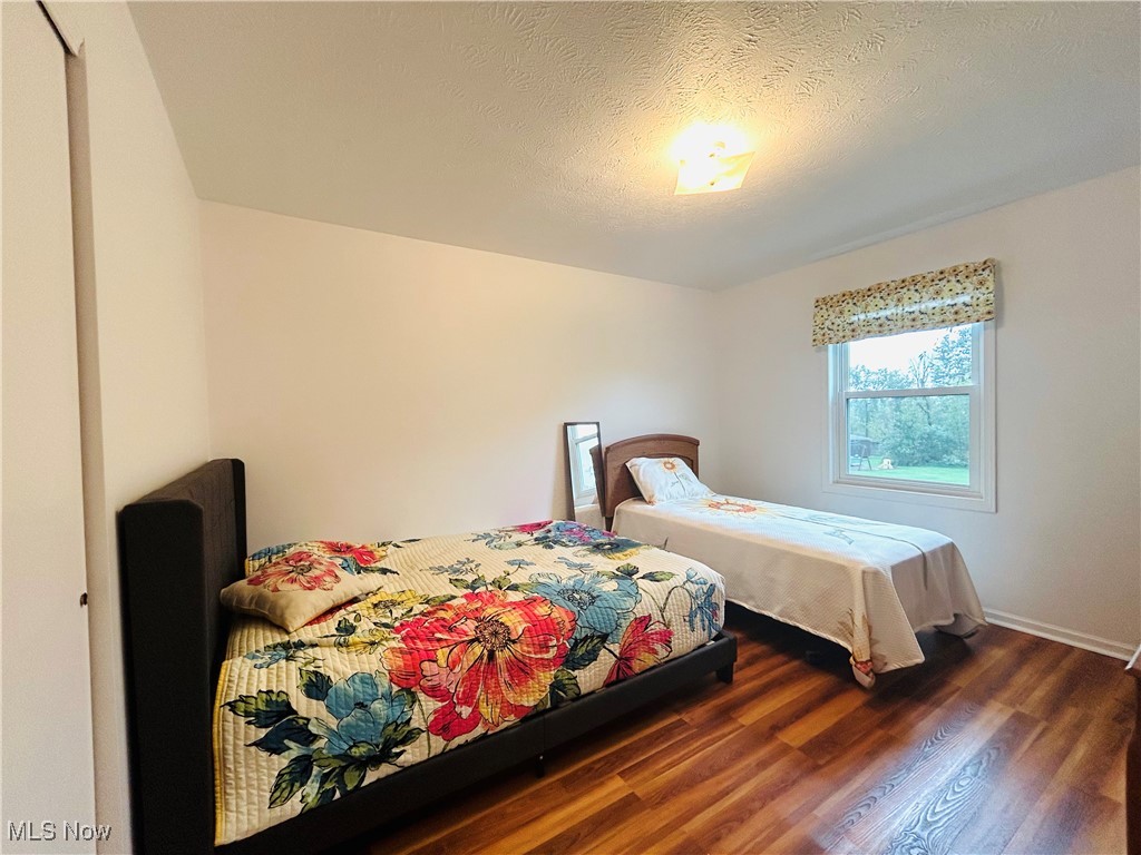 7028 Streeter Road Windham, OH 44288 - Photo 24 of 33 Bedroom featuring a textured ceiling and dark hardwood / wood-style floors