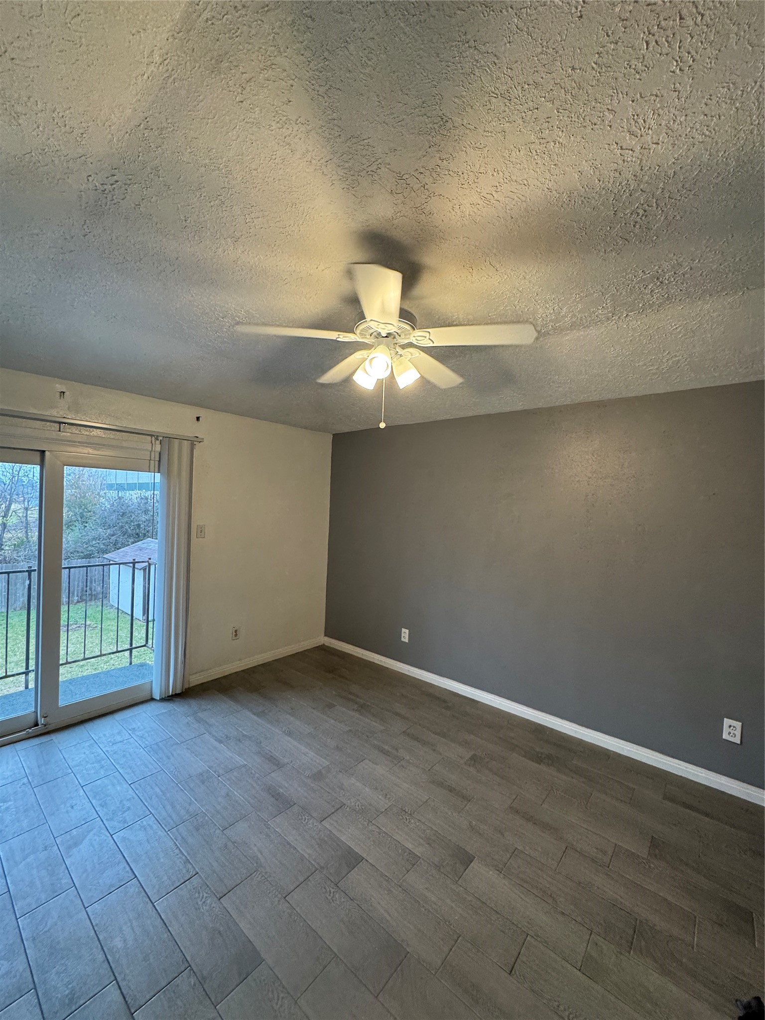8523 Redcliff Road Houston, TX 77064 - Photo 2 of 4 an empty room with windows and fan