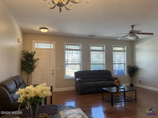 a living room with furniture potted plant and a window