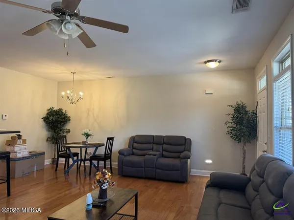 a living room with furniture and a chandelier